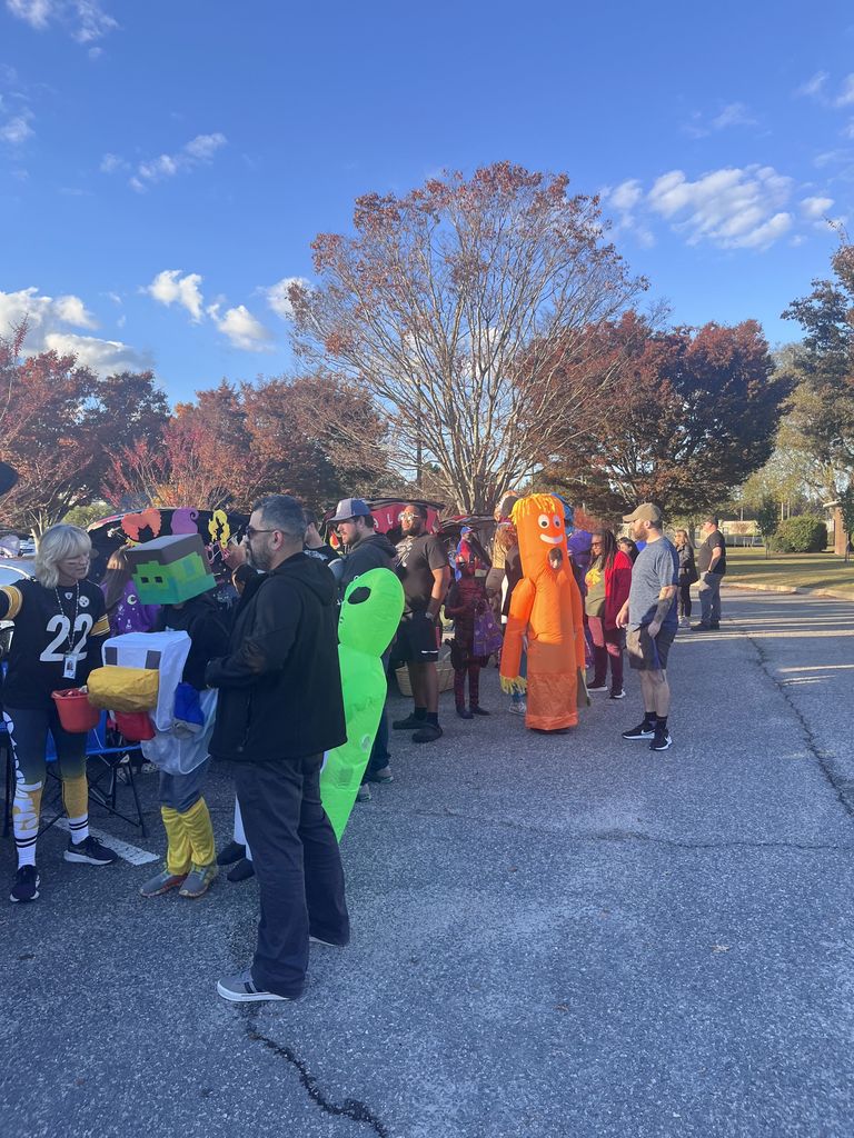 Kids lining up in costumes trunk or treating