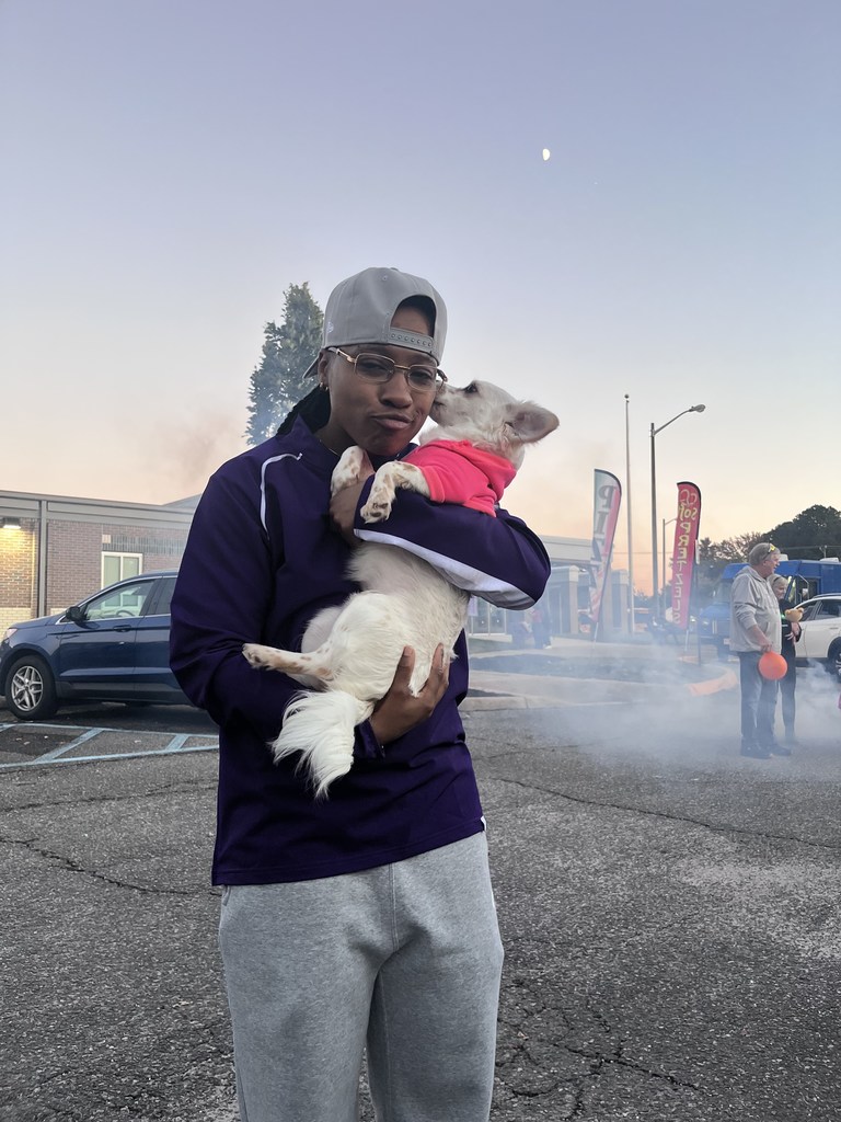 Ms. Vinson holding a dog at Trunk or treating