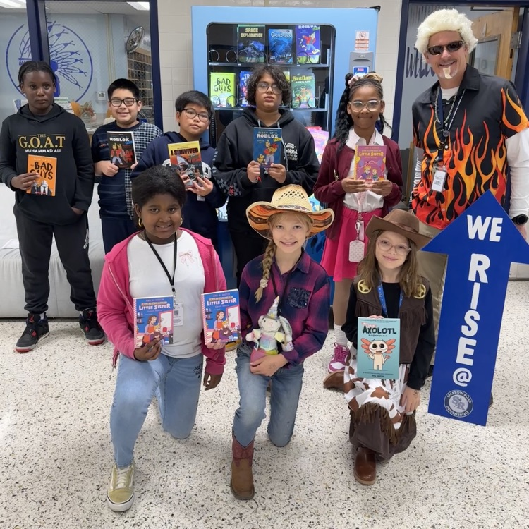 fifth grade students with the rise sign holding books 