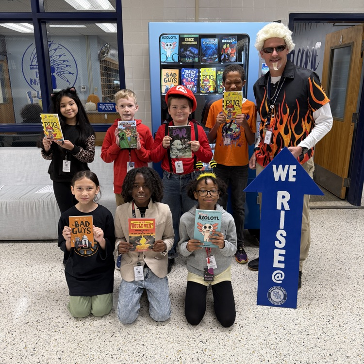 4th grade students holding books for respect