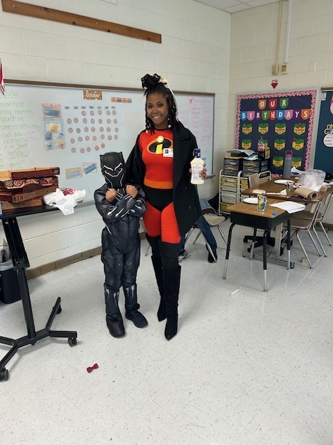student dressed as black panther (left) and his mom dressed as Mrs. Incredible (right)