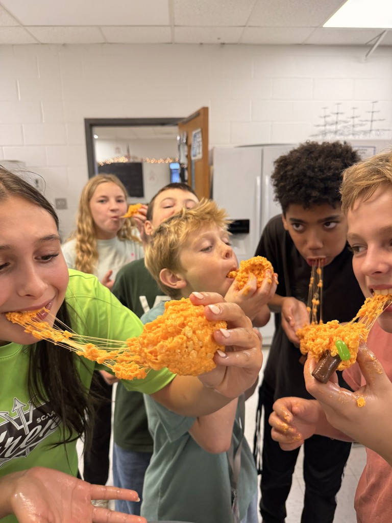 students eating rice krispy treat pumpkins
