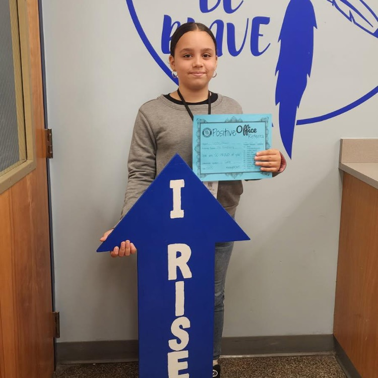 student with I RISE sign