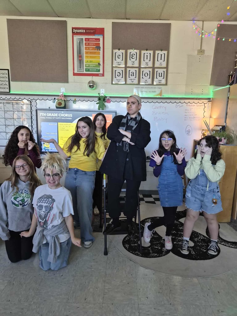 Mrs. Mercier dressed like Gru from Despicable Me and a few minions dressed in yellow.