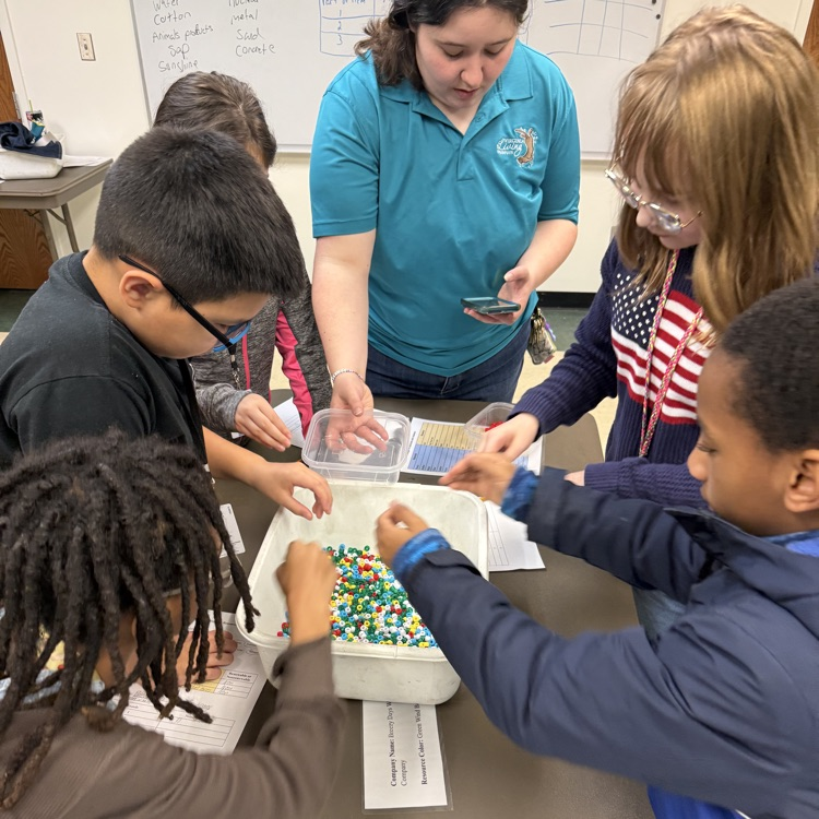 students in the learning lab around a bucket in a classroom