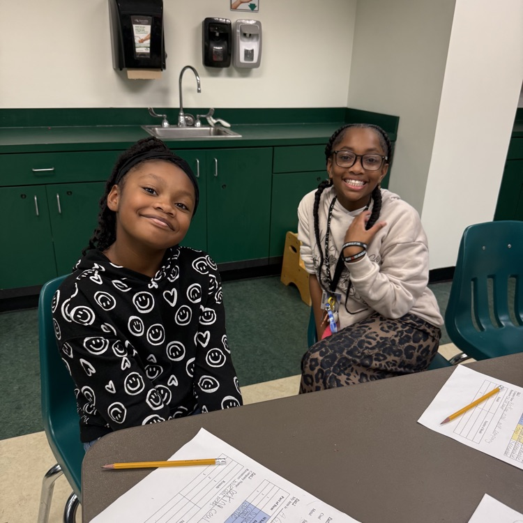 two girls in the learning lab  by a table 