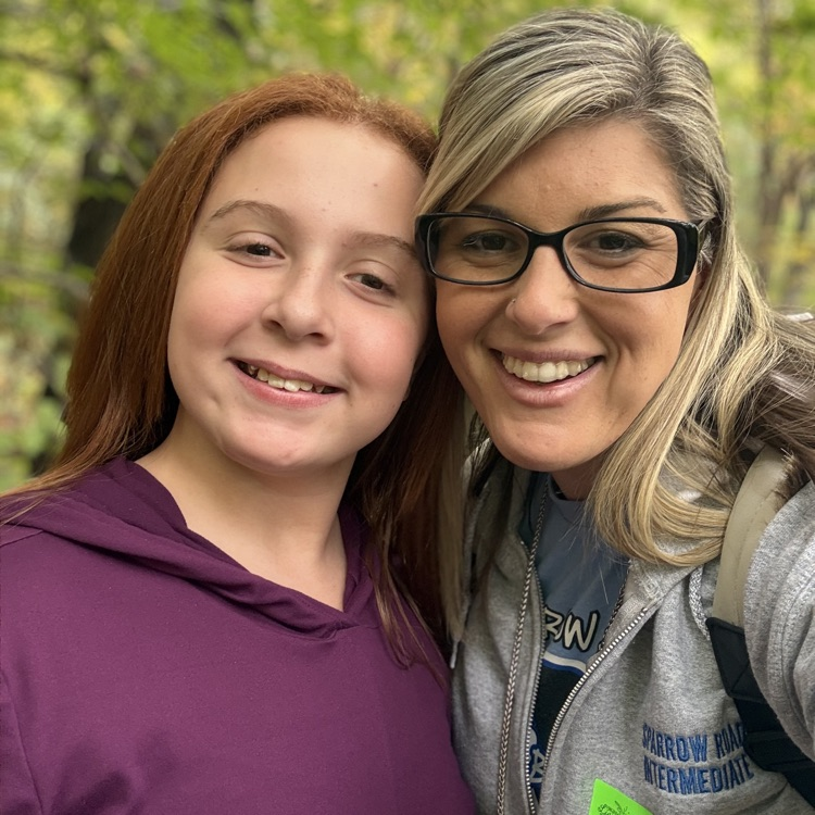 student and teacher smiling 