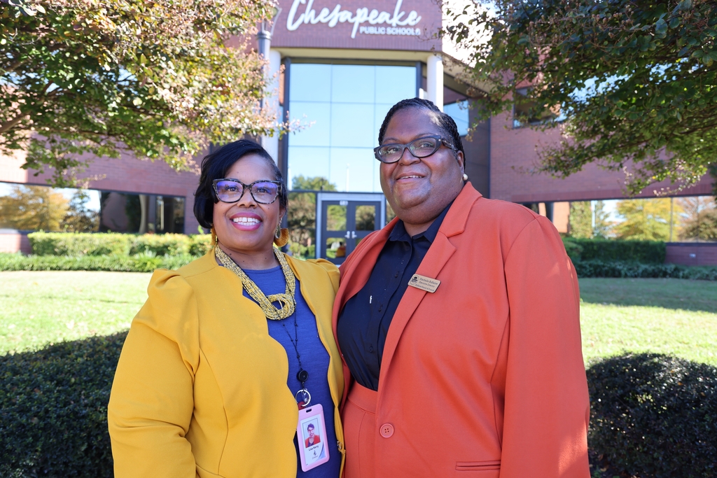 Lisa and Nischelle standing next together in from of the Chesapeake Public Schools Administration building and smiling.