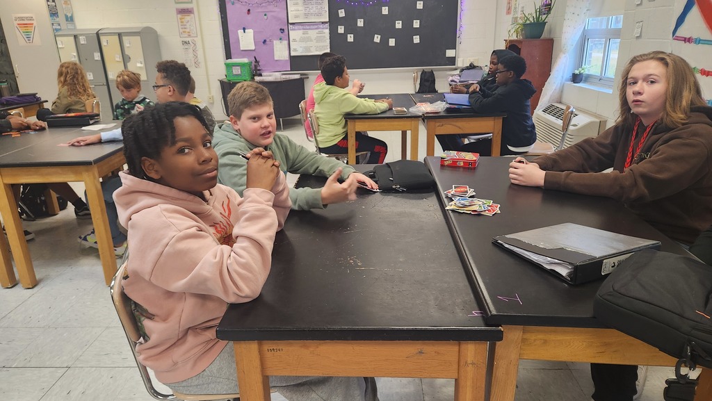 Three student play uno in the uno club