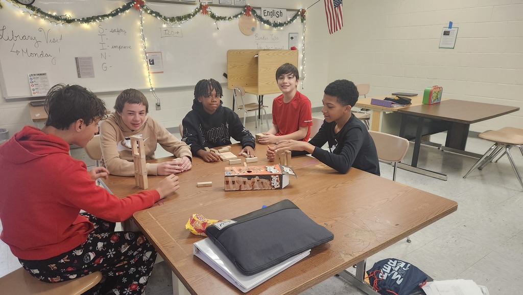 Students enjoying games in the game club. They have uno cards.