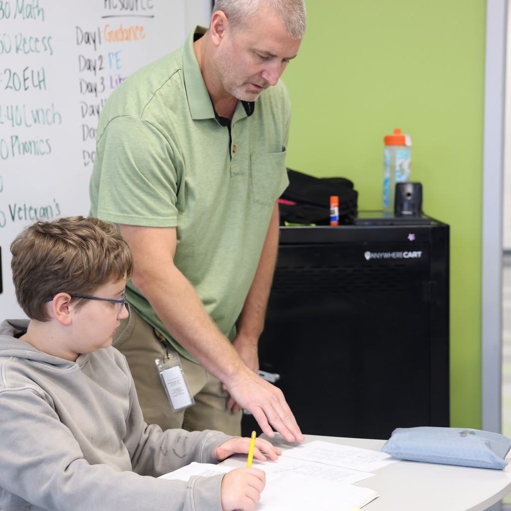 Teacher helping a student with his work.