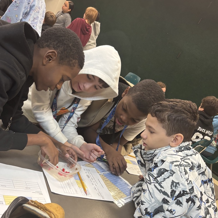 students working together at a table investigating energy sources 