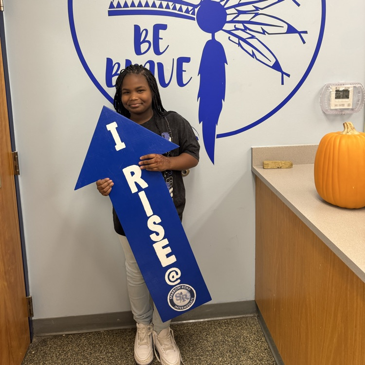 Student with I RISE sign