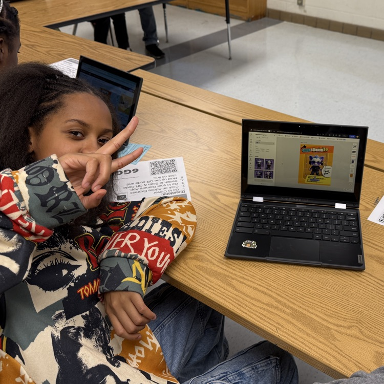 student with peace sign and computer with design 
