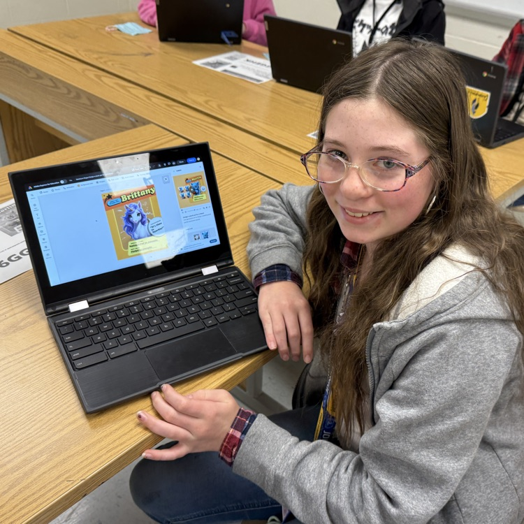 student with Brittany plush pal on computer