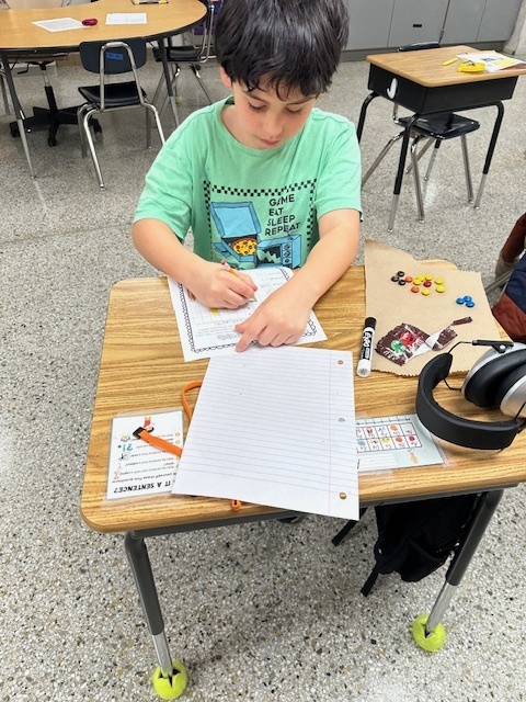 Student at desk with m&Ms and graphing paper