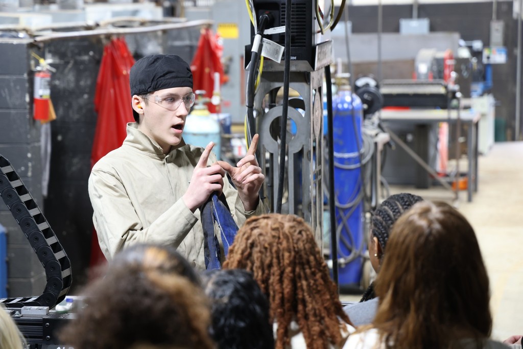 Welding student presenting to students