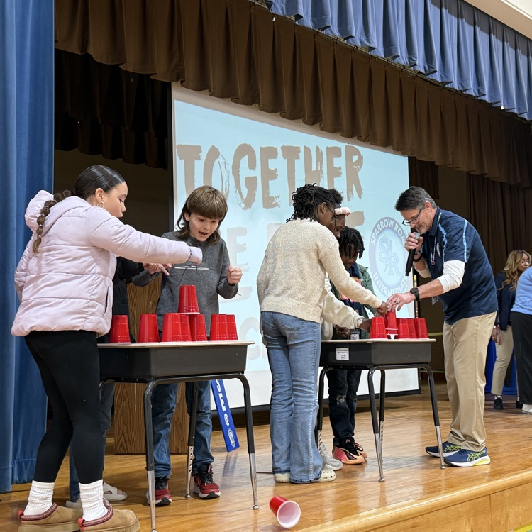 students working together for cup stacking challenge 