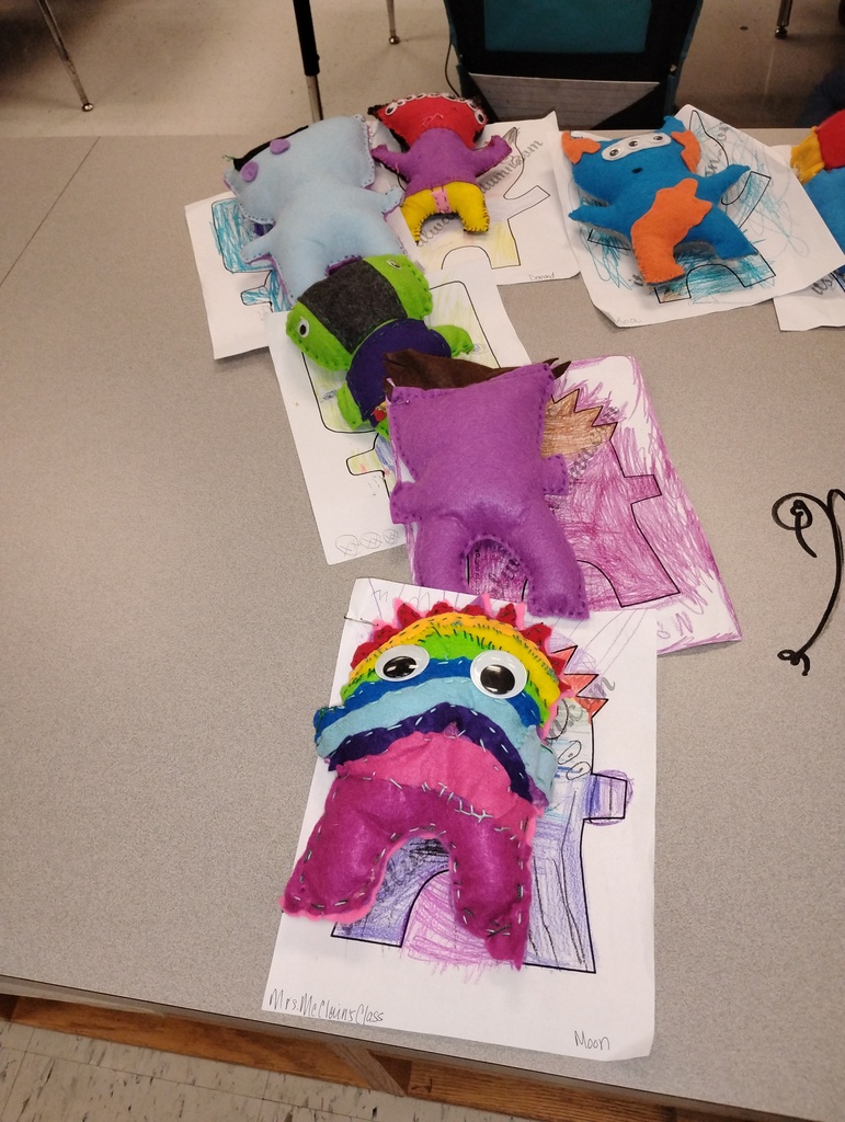 Plush monsters displayed from several students