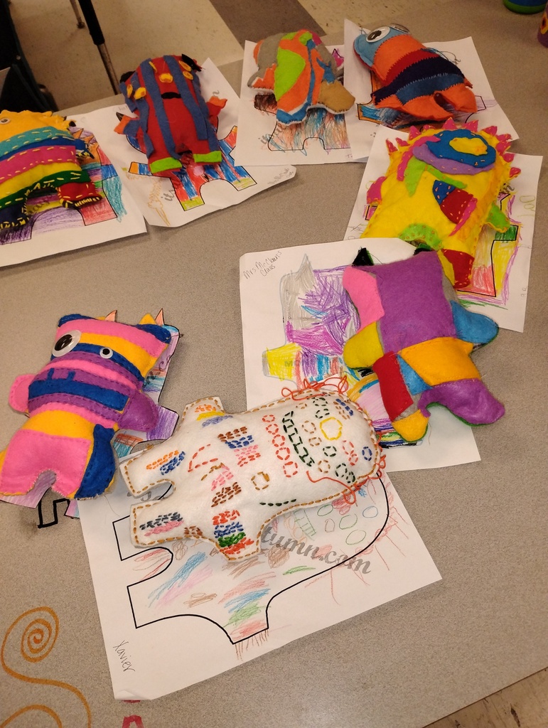 Plush monsters displayed from several students