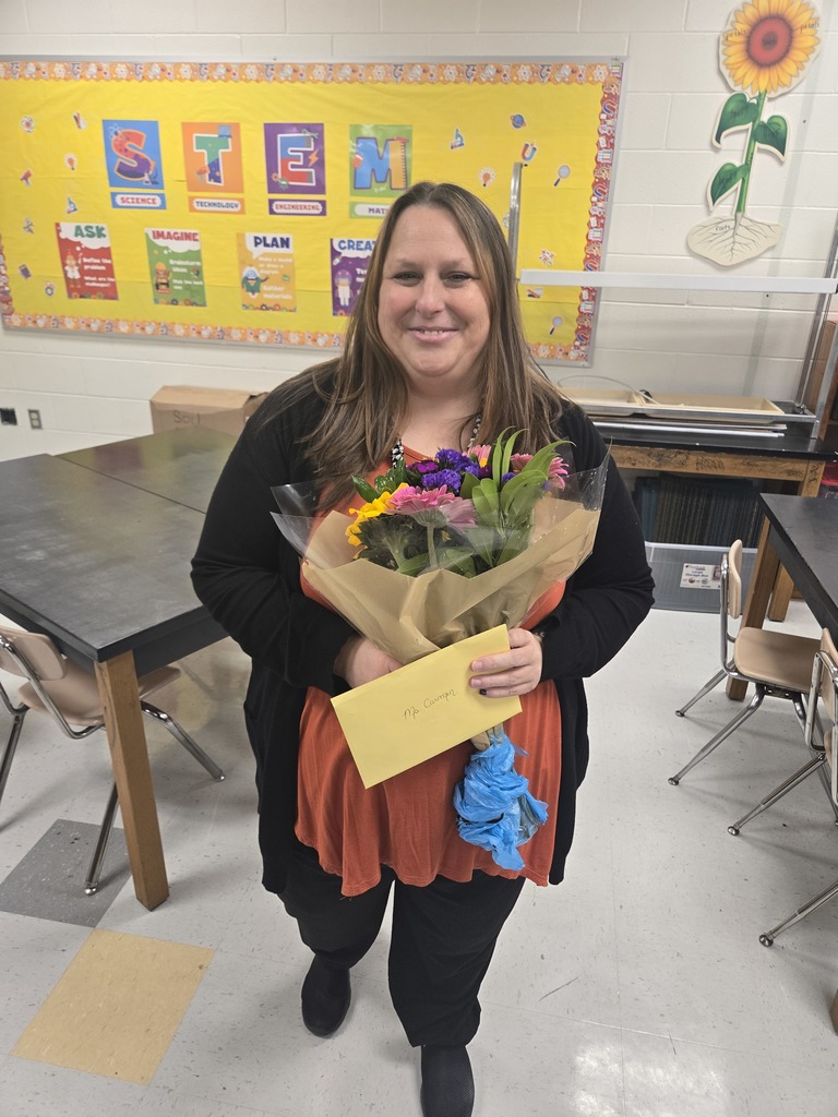 teacher holding flowers