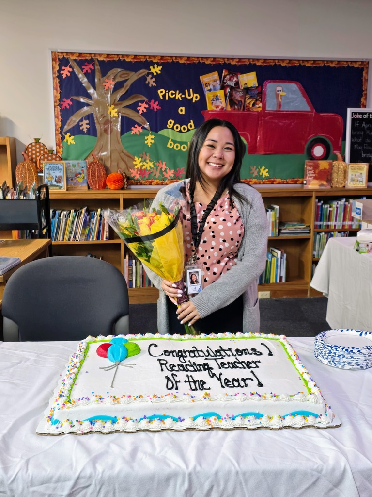 Alyssa Banas - GTP 2025-2026 Reading Teacher of the Year stand with her flowers and celebratory cake