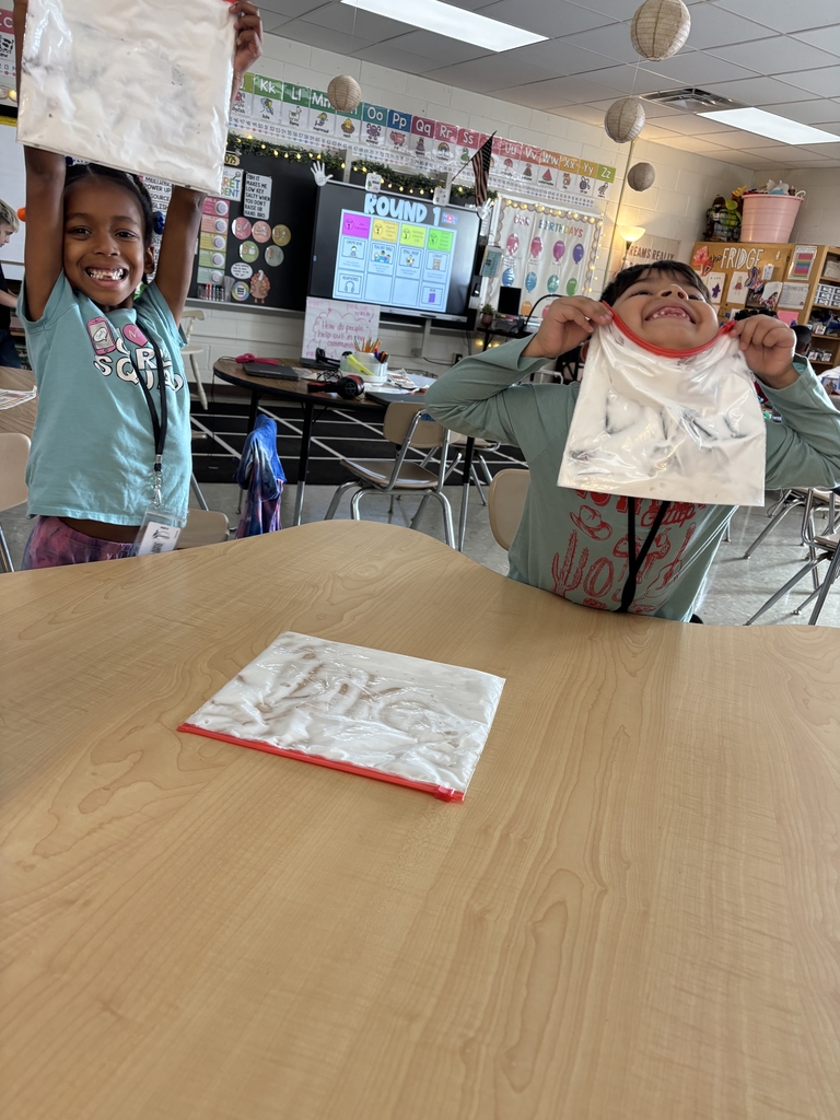 Students showing off their spelling words.