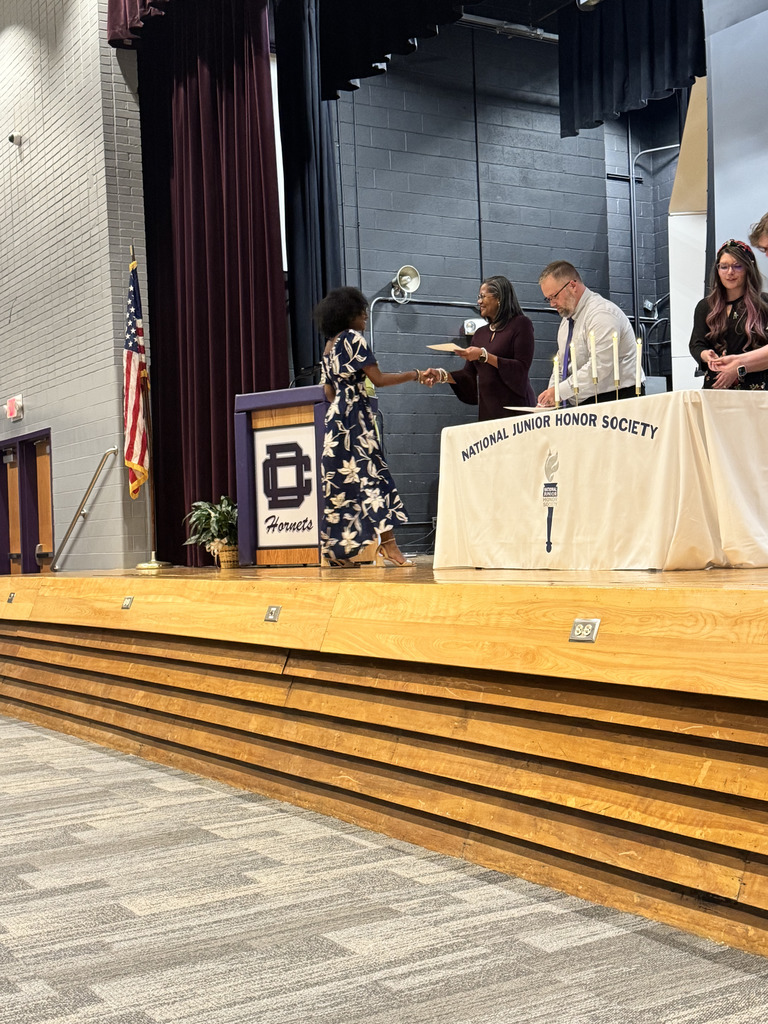 Student accepting national junior honor society certificate