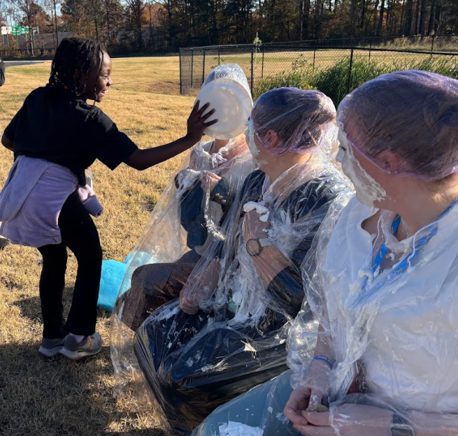 student throwing pie at teacher