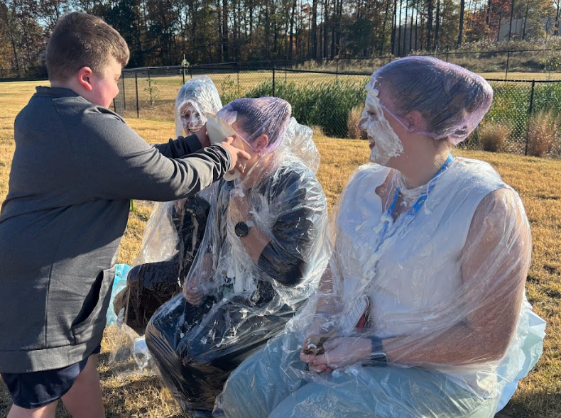 student throwing pie at teacher