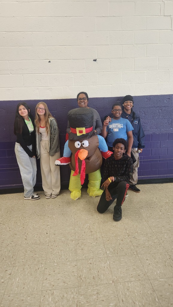 Dr.Page in a turkey costume with students.