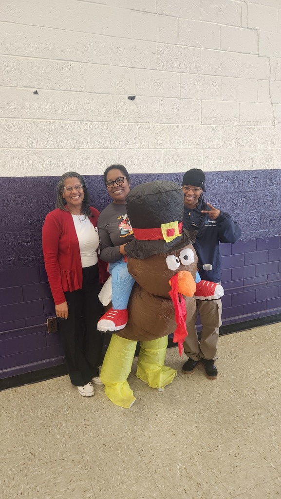 Dr. Davenport, Dr. Page, and Ms. Vinson. Dr. Page is wearing a turkey costume. 