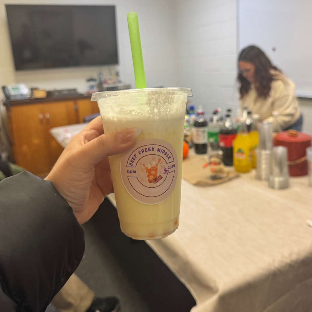 A teacher holding a soda cup