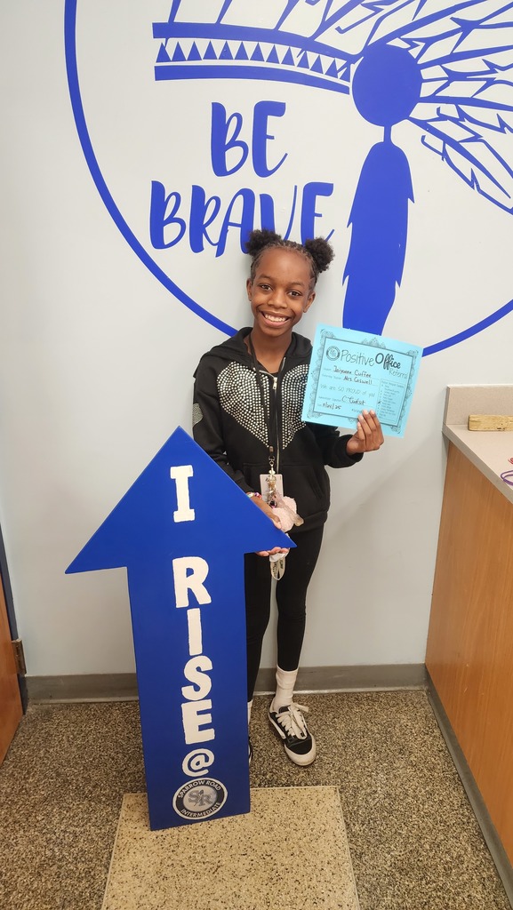 Student with the RISE arrow and Positive Office Referral Certifcate