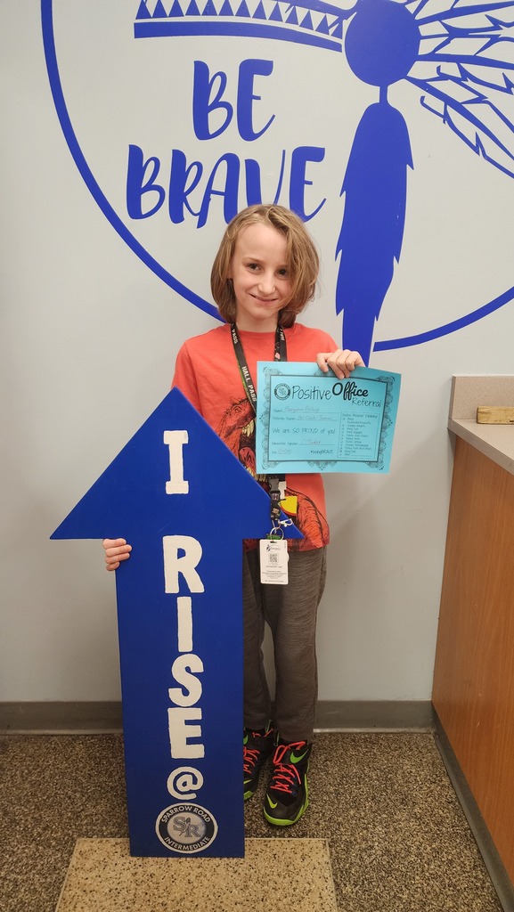 Student with the RISE arrow and Positive Office Referral Certifcate