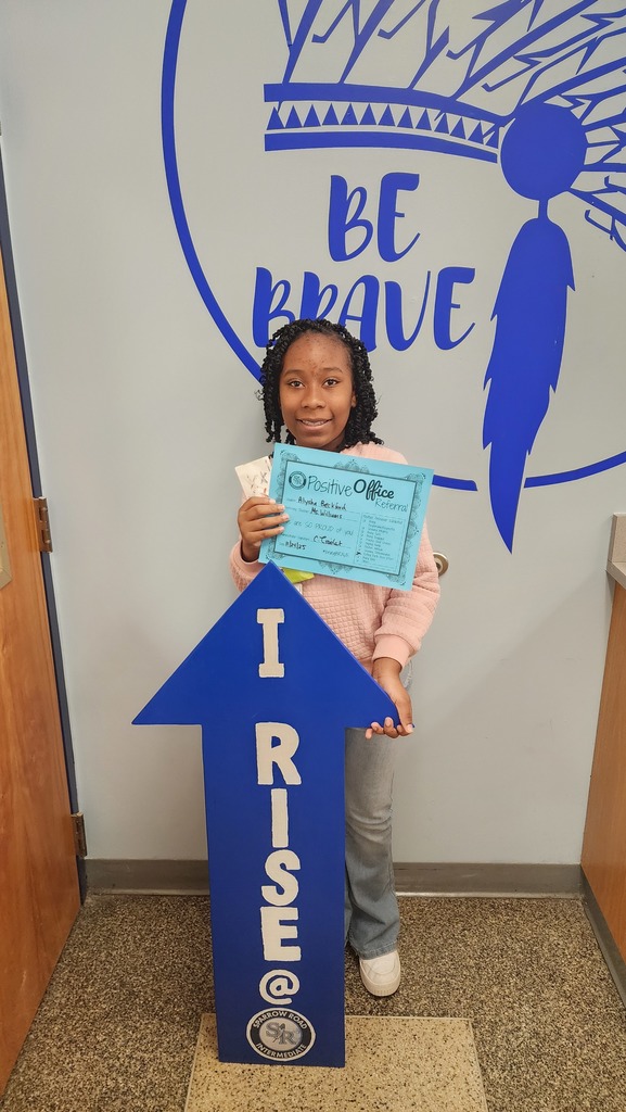 Student with the RISE arrow and Positive Office Referral Certifcate