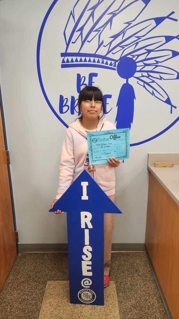 Student with the RISE arrow and Positive Office Referral Certifcate
