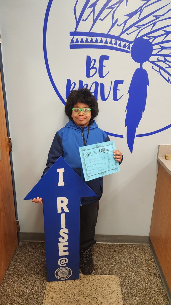 Student with the RISE arrow and Positive Office Referral Certifcate