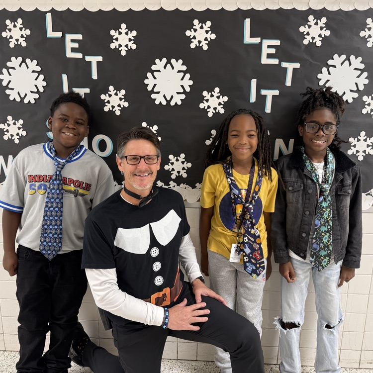 Mr Triolet with three students wearing ties 
