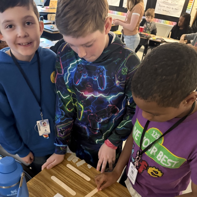 students using popsicle sticks to make their turkey traps