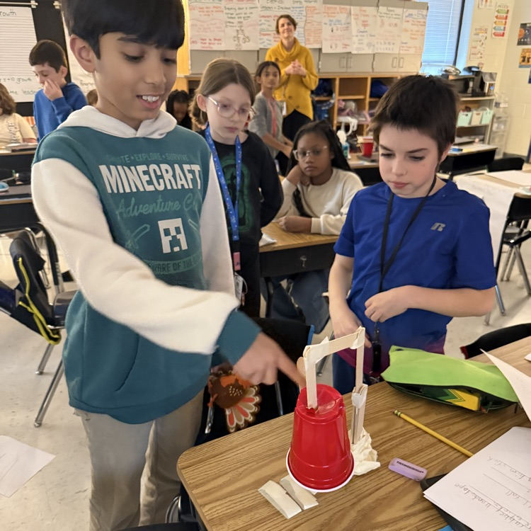 students using popsicle sticks and cups to make their turkey traps