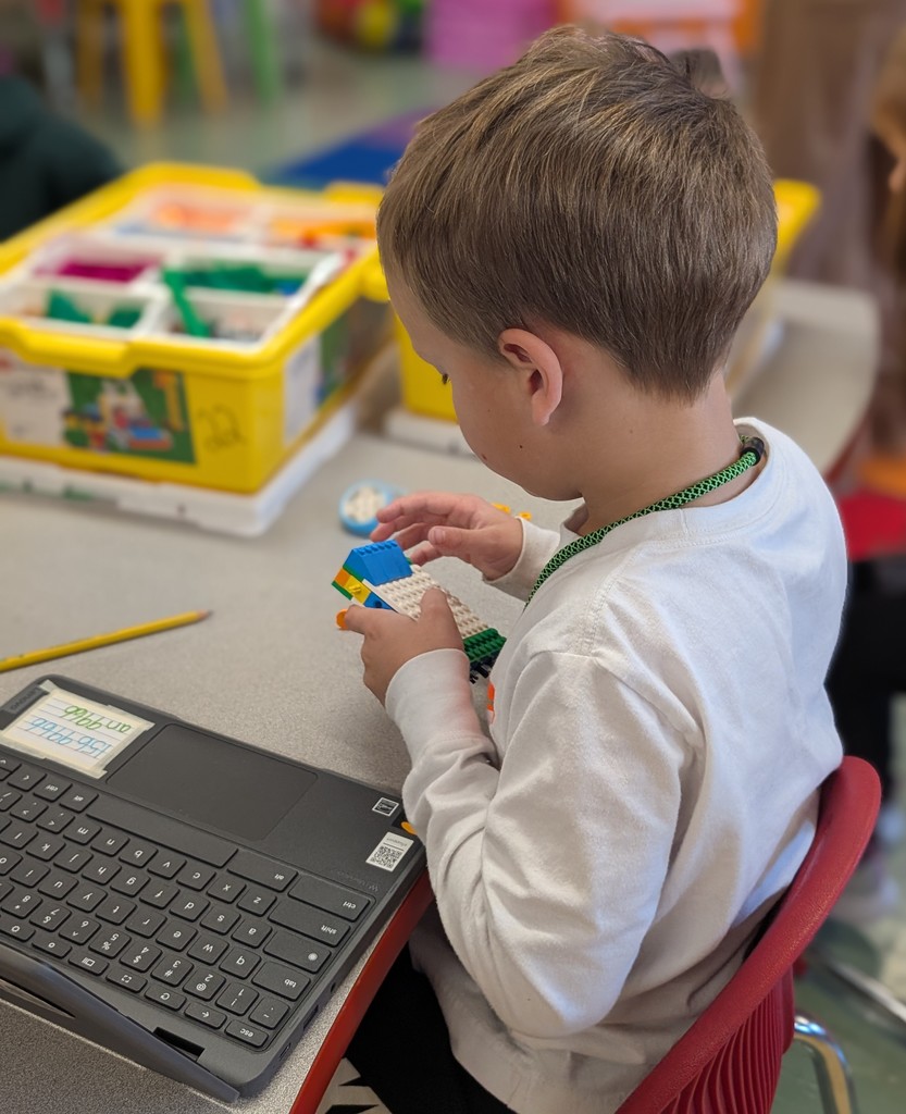 Kindergarten students building a Lego car to measure and then measure the distance it will travel at varying speeds.