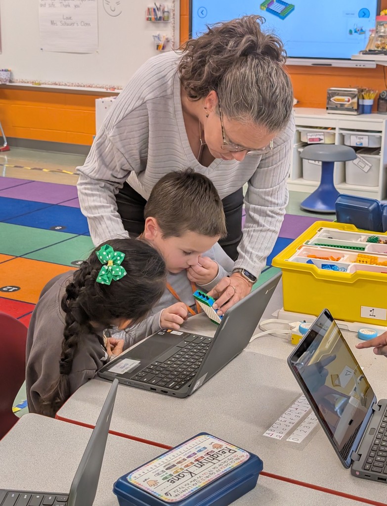 Kindergarten students building a Lego car to measure and then measure the distance it will travel at varying speeds.