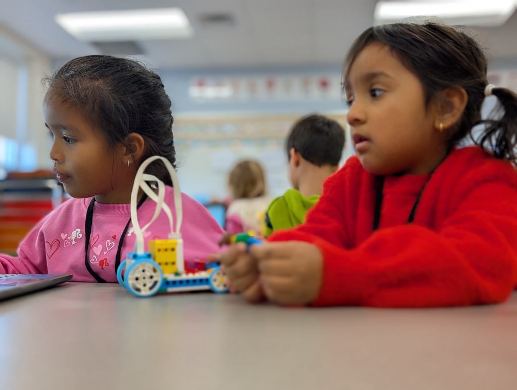 Kindergarten students building a Lego car to measure and then measure the distance it will travel at varying speeds.