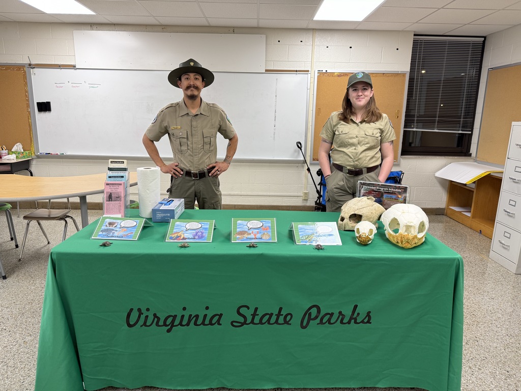Rangers Manny and Hannah at the Virginia State Parks table with sea turtle skulls