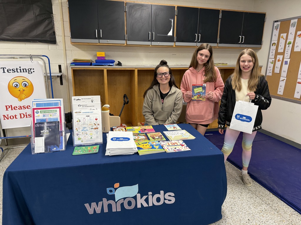 WHRO kids table with two students and books to give away