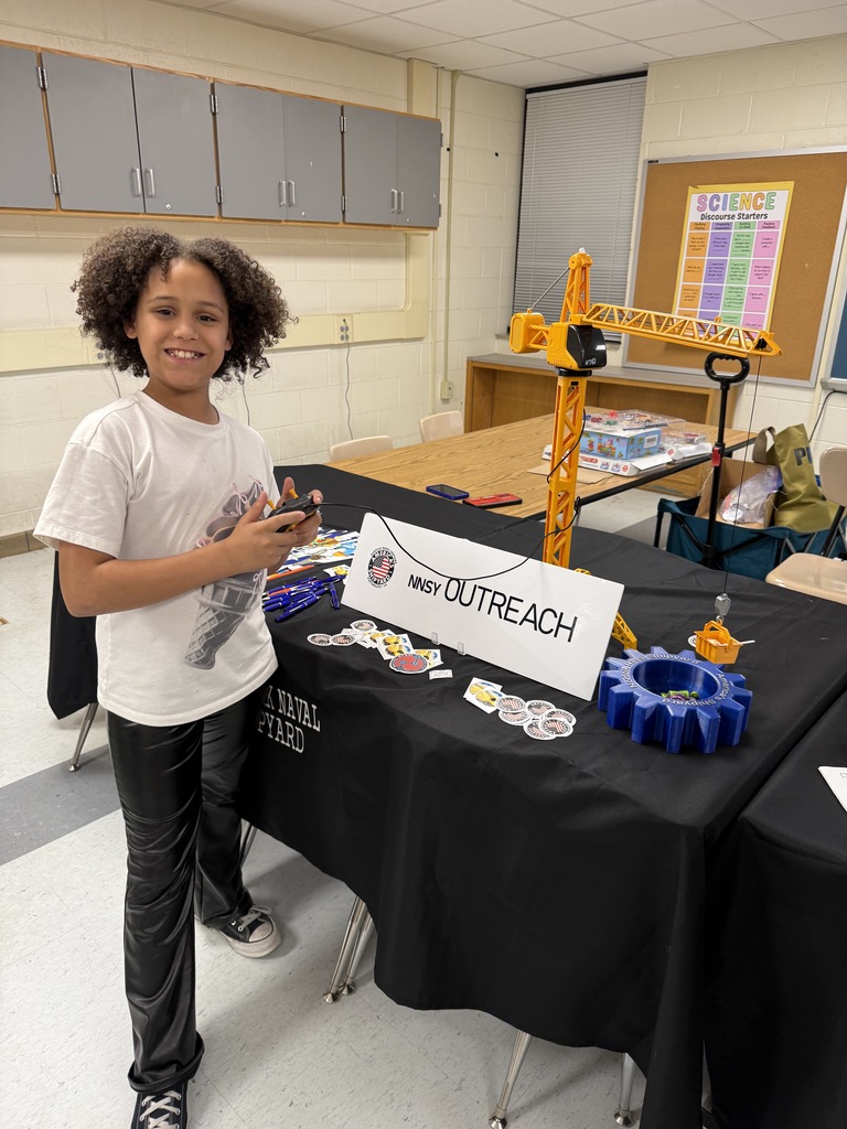 NNSY Outreach table with student and crane
