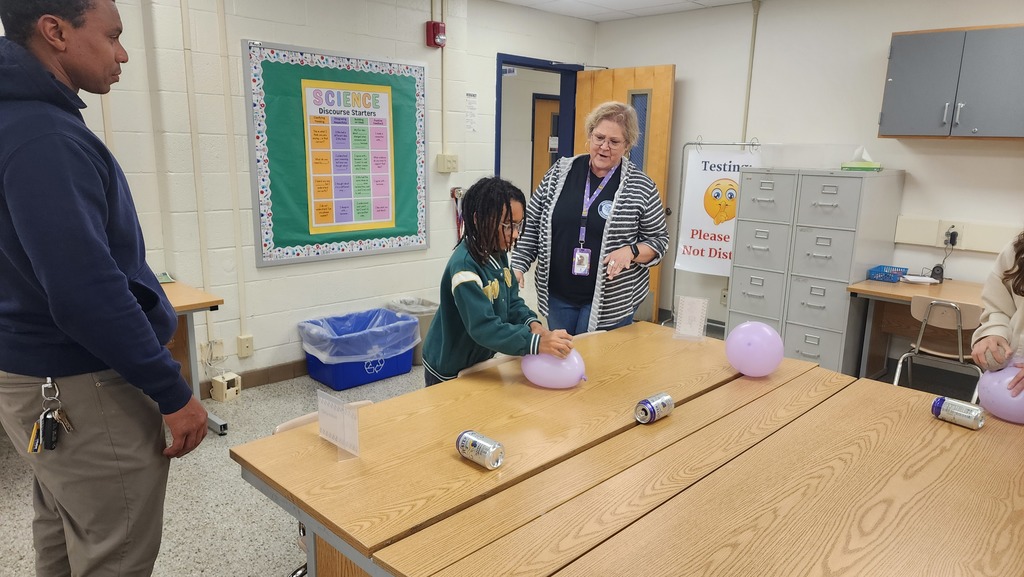 Presenter and student using a balloon to move a can