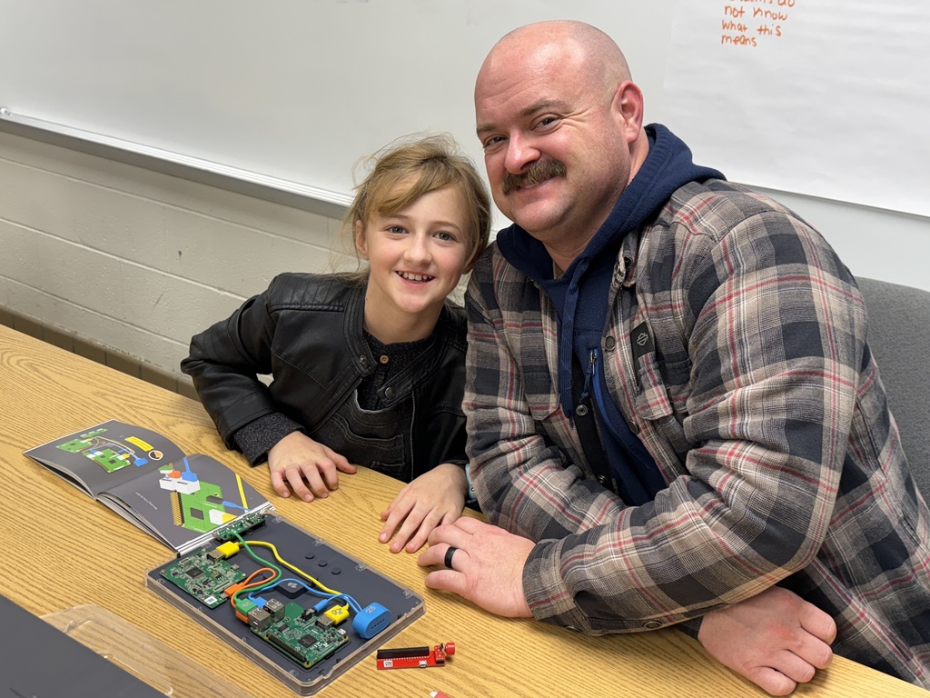 Father and daughter building a computer