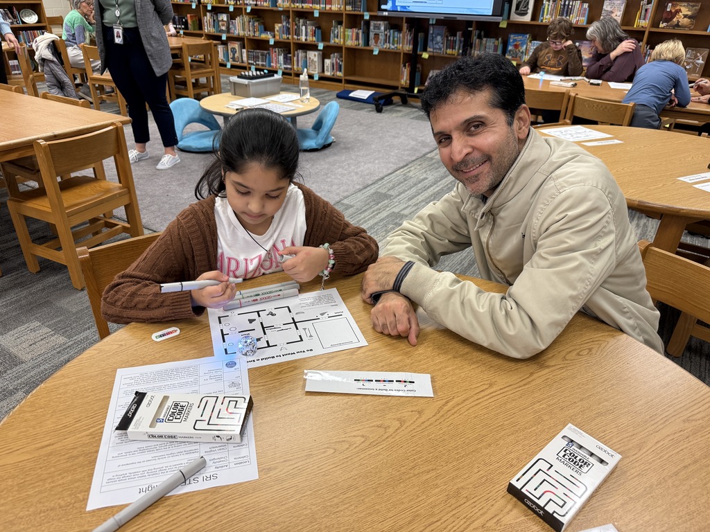 Parent and child working on color codes with ozobots